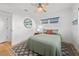 Comfortable bedroom with natural light, ceiling fan, and wood-look flooring at 17730 Long Point Dr, Redington Shores, FL 33708