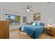Bright bedroom with a waterfront view, ceiling fan, and light wood floors at 17730 Long Point Dr, Redington Shores, FL 33708
