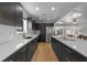 Bright kitchen with quartz countertops, stainless steel appliances, and black cabinetry at 17730 Long Point Dr, Redington Shores, FL 33708