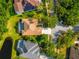 Aerial view of the property featuring a private pool, screened-in lanai, and well-manicured landscaping at 18310 Bankston Pl, Tampa, FL 33647