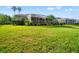 Expansive backyard featuring a screened-in lanai, lush green lawn, and mature landscaping at 18310 Bankston Pl, Tampa, FL 33647