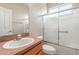 Bathroom featuring a shower and tub combination with sliding glass doors, a sink with countertop, and a toilet at 18310 Bankston Pl, Tampa, FL 33647