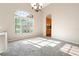 Sunlit dining room with a large window, offering a view of the outside, complemented by an elegant chandelier at 18310 Bankston Pl, Tampa, FL 33647