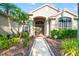 Close-up of the front entrance with a walkway, well-manicured landscaping, and a decorative front door at 18310 Bankston Pl, Tampa, FL 33647