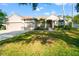 Charming single-story home featuring a well-maintained lawn, a two-car garage, and a welcoming entrance at 18310 Bankston Pl, Tampa, FL 33647