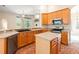 Functional kitchen featuring a center island, tile floors, and views of the living spaces at 18310 Bankston Pl, Tampa, FL 33647