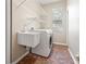Functional laundry room with tile floors, sink, and washer/dryer at 18310 Bankston Pl, Tampa, FL 33647