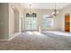 Bright and open living room with high ceilings, large windows, and a clear view of the entrance at 18310 Bankston Pl, Tampa, FL 33647