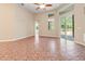 Open living room with tiled floors, recessed lighting, sliding doors and windows providing an airy feel at 18310 Bankston Pl, Tampa, FL 33647