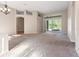 Spacious living room featuring neutral walls and providing access to the outdoor area at 18310 Bankston Pl, Tampa, FL 33647