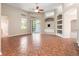 Spacious living room with tiled floors, built-in shelving, and sliding glass doors leading to the patio at 18310 Bankston Pl, Tampa, FL 33647