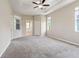 Spacious main bedroom with tray ceilings, carpet, neutral walls, closet, and windows for natural light at 18310 Bankston Pl, Tampa, FL 33647