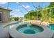 Inviting pool and spa area with a screened enclosure, perfect for enjoying the outdoors at 18310 Bankston Pl, Tampa, FL 33647