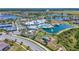 Expansive aerial view of community amenities including a pool, lakes, and recreation areas at 19442 Sea Glass Cir, Land O Lakes, FL 34638