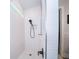 Modern bathroom featuring a walk-in shower with sleek black hardware and white horizontal tiling at 19442 Sea Glass Cir, Land O Lakes, FL 34638