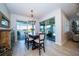 Elegant dining room with chandelier lighting and sliding glass doors leading to patio at 19442 Sea Glass Cir, Land O Lakes, FL 34638
