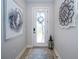 Bright entryway with a decorative front door, stylish accents, and neutral paint at 19442 Sea Glass Cir, Land O Lakes, FL 34638