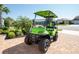 Eye-catching bright green golf cart parked on a paver driveway with manicured landscaping at 19442 Sea Glass Cir, Land O Lakes, FL 34638