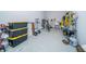 Spacious garage with epoxy flooring, storage containers, and various organizational elements at 19442 Sea Glass Cir, Land O Lakes, FL 34638