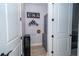 Hallway with decorative USA themed accents, grey cabinetry, and light wood floors at 19442 Sea Glass Cir, Land O Lakes, FL 34638