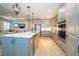 Spacious kitchen with light gray cabinets, a center island, and stainless steel appliances at 19442 Sea Glass Cir, Land O Lakes, FL 34638
