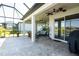 Covered lanai with stylish outdoor seating, ceiling fans, and views of the backyard at 19442 Sea Glass Cir, Land O Lakes, FL 34638