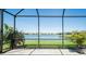Screened lanai with a scenic lake view and well-maintained landscaping at 19442 Sea Glass Cir, Land O Lakes, FL 34638