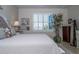 Comfortable bedroom featuring a tufted headboard, shuttered window, and ample natural light at 19442 Sea Glass Cir, Land O Lakes, FL 34638
