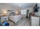 Inviting main bedroom with a decorative bed, plantation shutters, and plenty of natural light at 19442 Sea Glass Cir, Land O Lakes, FL 34638