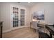Office space features French doors, wood flooring, a desk, and elegant decor at 19442 Sea Glass Cir, Land O Lakes, FL 34638