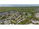Picturesque aerial view showcases the community nestled amongst lush trees and serene ponds with ocean view at 195 114Th Ne Ave # 195, St Petersburg, FL 33716