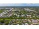 High angle aerial view of multiple homes with a lake view and lush green trees in the background at 195 114Th Ne Ave # 195, St Petersburg, FL 33716