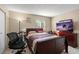 Bedroom with a large bed, TV, exercise bike, and natural light from the window at 195 114Th Ne Ave # 195, St Petersburg, FL 33716