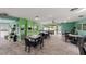 Bright dining area boasts ample seating, an exit sign, and seamlessly connects to a kitchen for convenient meal service at 195 114Th Ne Ave # 195, St Petersburg, FL 33716