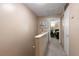Hallway to the main bedroom with neutral paint, leading to a room with a desk at 195 114Th Ne Ave # 195, St Petersburg, FL 33716
