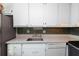 Bright kitchen with white cabinets, stainless steel appliances, and granite countertops at 195 114Th Ne Ave # 195, St Petersburg, FL 33716