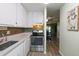 Kitchen with sleek stainless steel appliances and convenient access to the dining area at 195 114Th Ne Ave # 195, St Petersburg, FL 33716