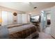 Relaxing bedroom featuring a comfortable bed, a TV, and a serene view to an adjoining room at 195 114Th Ne Ave # 195, St Petersburg, FL 33716