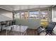 Enclosed porch with a ping pong table and a view of the community at 195 114Th Ne Ave # 195, St Petersburg, FL 33716