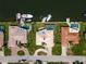 Aerial shot of a home with a dock, pool, and beautiful landscaping, situated on a waterfront canal at 2015 Hawaii Ne Ave, St Petersburg, FL 33703