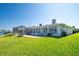 Expansive backyard featuring a well-maintained lawn, outdoor patio, and pool with stunning backyard water view at 2015 Hawaii Ne Ave, St Petersburg, FL 33703