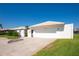 Beautiful home exterior with a wide driveway, two-car garage, and well-maintained landscaping at 2015 Hawaii Ne Ave, St Petersburg, FL 33703