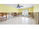 Bright living room area under renovation with white tile floors and double doors to back patio at 2015 Hawaii Ne Ave, St Petersburg, FL 33703