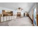 Large living room under renovation with multiple ceiling fans and natural light from large windows at 2015 Hawaii Ne Ave, St Petersburg, FL 33703