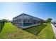 Sparkling pool surrounded by a screened enclosure, lawn, and waterfront views at 2015 Hawaii Ne Ave, St Petersburg, FL 33703