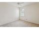This bedroom features a ceiling fan, neutral carpet, and a window for natural light at 20606 Whitewood Way, Tampa, FL 33647