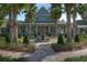 Charming clubhouse entrance with a fountain, set amidst palm trees and manicured landscaping at 20606 Whitewood Way, Tampa, FL 33647