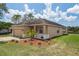 Well maintained house near the water with a two car garage, beautiful landscaping, and tan stucco siding at 20606 Whitewood Way, Tampa, FL 33647
