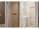 Bright laundry room with washer, dryer, built-in shelving and tile floors at 20606 Whitewood Way, Tampa, FL 33647