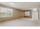 Spacious carpeted living room with natural light from large windows, blinds, and neutral walls at 20606 Whitewood Way, Tampa, FL 33647